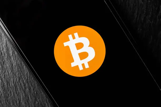 Photo of Logo of Bitcoin digital cryptocurrency money on the screen of a smartphone