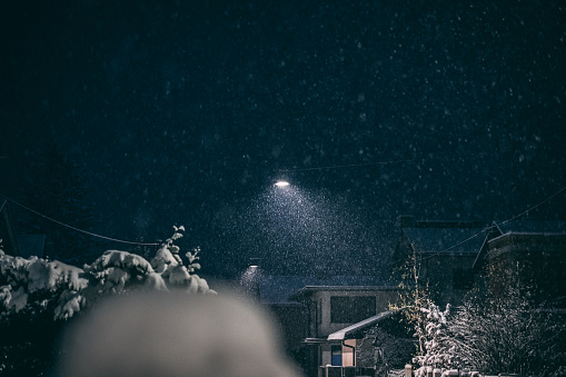 Snow-Covered street Lit by Street Lights