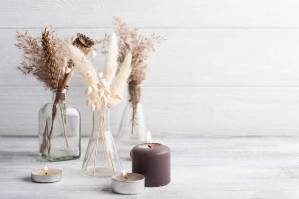 istock Lit aroma candle and dry flowers 1289094091