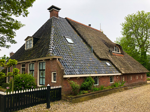 Ee, Friesland, Netherlands: A traditional Dutch house with a thatched roof in the village of Ee, Netherlands.