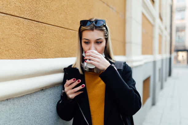 istock Beautiful young Caucasian woman using a smart phone 1289095724