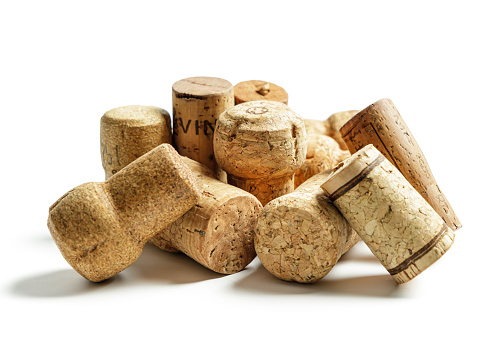 various corks from wine bottles on a white background