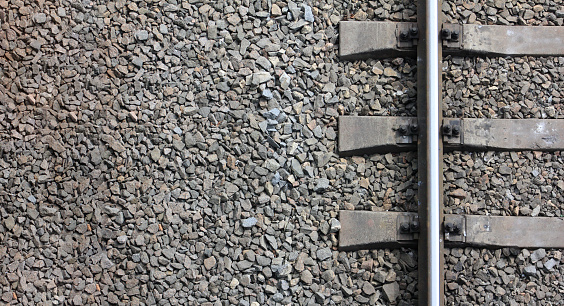 Fragment of the old railway track close-up. View from above. Background freight transport.