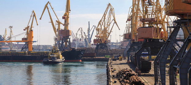Lifting cargo cranes, ships and grain dryer in Sea Port of Odessa, Black Sea, Ukraine
