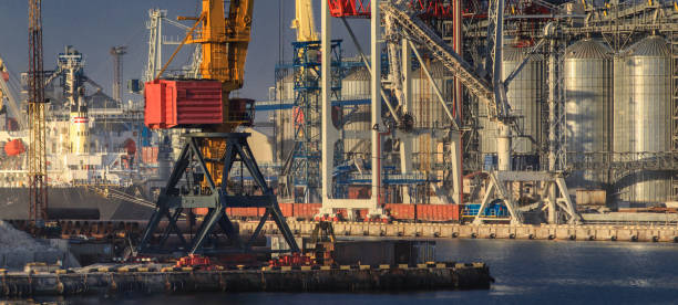 Lifting cargo cranes, ships and grain dryer in Sea Port of Odessa, Black Sea, Ukraine Lifting cargo cranes, ships and grain dryer in Sea Port of Odessa, Black Sea, Ukraine odessa beach stock pictures, royalty-free photos & images