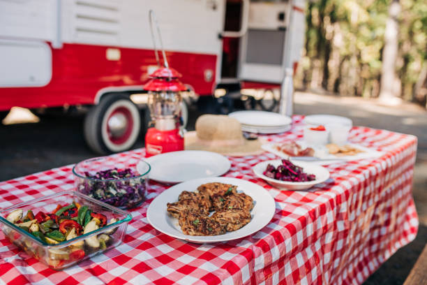 istock Feast on a Red and White Tablecloth by an RV in the Forest 1289101503