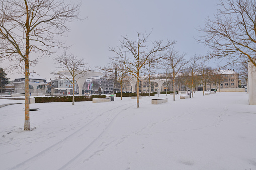 Darmstadt, Germany, 01 Dec 2020: Georg Büchner Platz, covered by snow in a cloudy morning
