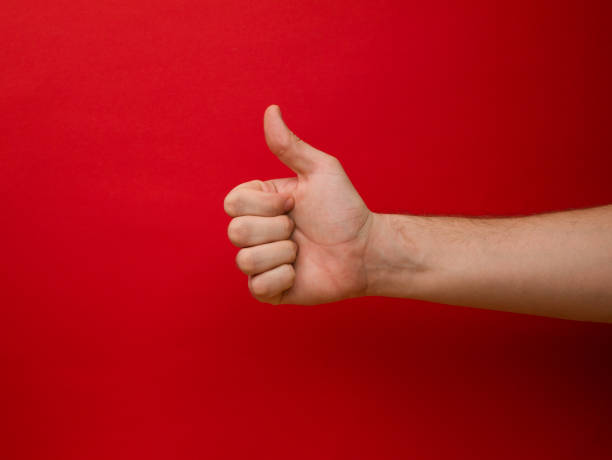 istock Female hand shows thumb up gesture on a background 1289108790