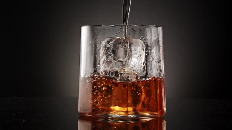 whiskey pouring on ice