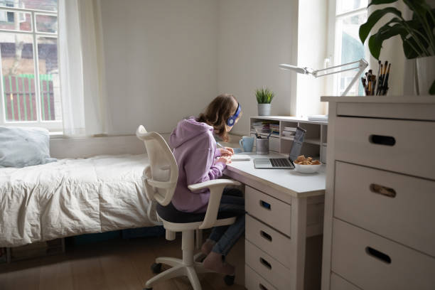 istock Smart teenage girl study on computer at home 1289115868