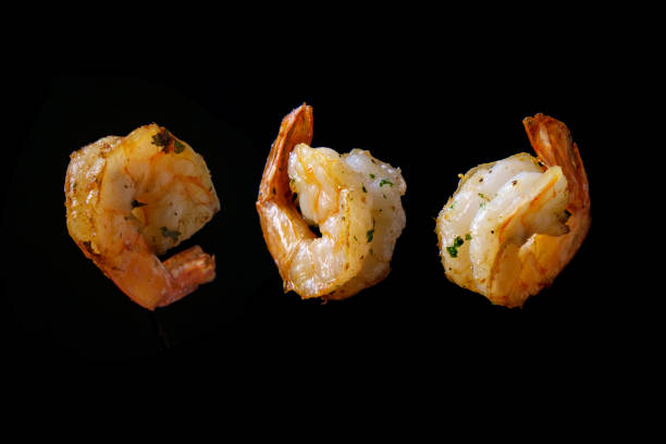 Tossing Cooking Floating Shrimp Stir frying and tossing shrimp floating in air closeup food state preparation shrimp prepared shrimp stock pictures, royalty-free photos & images