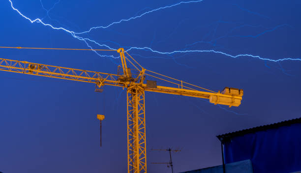lightning over construction crane in the city
