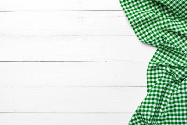 istock checkered tablecloth on wooden table. creative photo. 1289118796