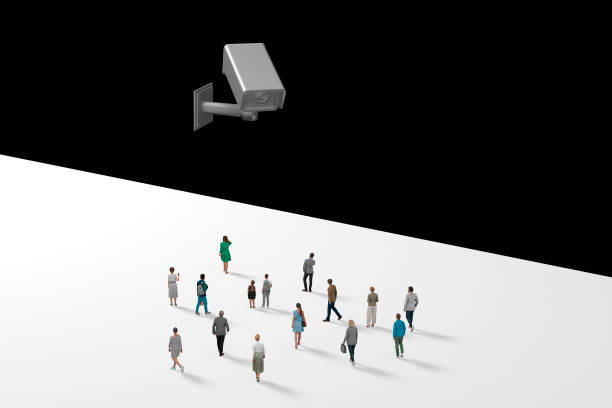 istock Group Of Architectural Figurines Walking Towards A CCTV Camera, Studio Shot, Isolated Against White 1289119509