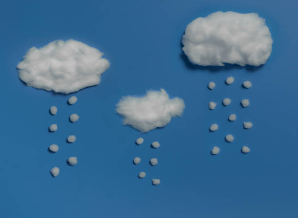 istock White cotton clouds and raindrops on sky blue background,Minimal concept,Space for text 1289121424