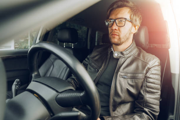 istock Confident young man sitting in a car 1289121447