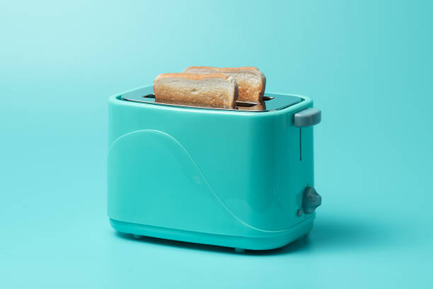 istock Toaster with bread slices on mint green background 1289121511