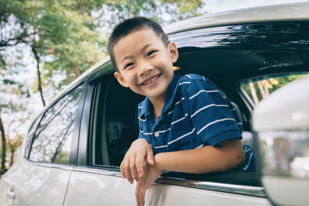 istock Happy little boy sitting in the car 1289128396