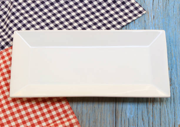 istock white plate on tablecloth on wood table background 1289133897