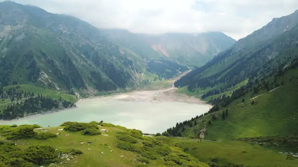 Photo of Big Almaty lake in the mountains. Green hill