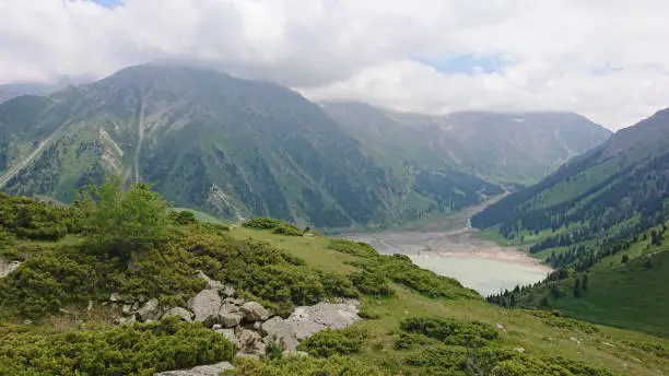 Photo of Big Almaty lake in the mountains. Green hill