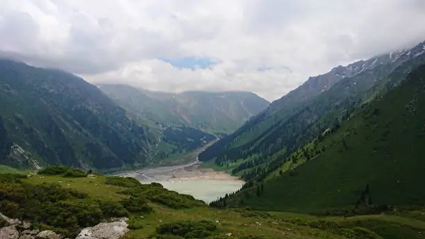 Photo of Big Almaty lake in the mountains. Green hill