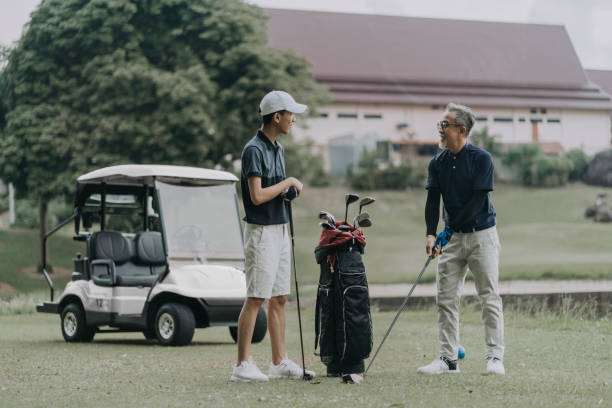istock asian chinese father teaching his son to play golf at golf course 1289137102