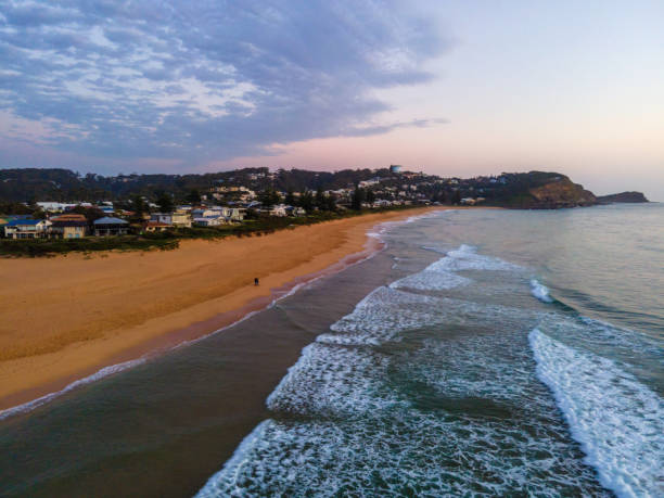 Soft haze and pastel coloured sunrise seascape Soft and pale aerial sunrise at the beach in Avoca Beach on the Central Coast, NSW, Australia. avoca beach photos stock pictures, royalty-free photos & images