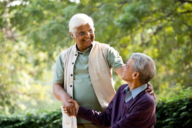 istock Two senior men greeting each other at park 1289138809