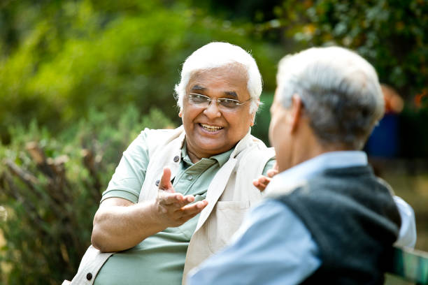 istock Two senior men discussing on park bench 1289138972