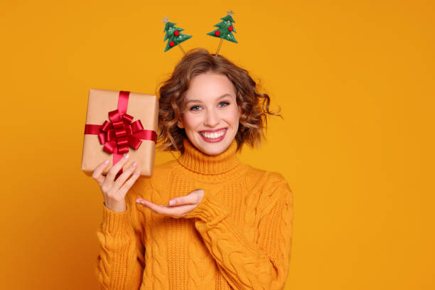 istock Glad young female with Christmas gift 1289140099