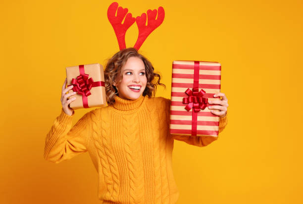 istock Glad young female with Christmas presents 1289140674