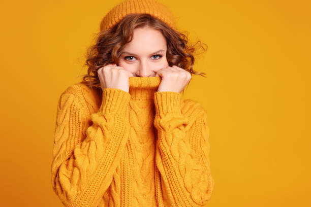 istock Happy female  hid wrapped up in warm sweater 1289140688