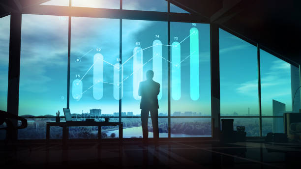 istock Businessman looks at the growth graph in the evening office. 1289140816