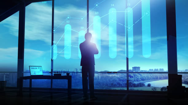 istock A businessman looks at a growth graph hologram at dusk. 1289140820