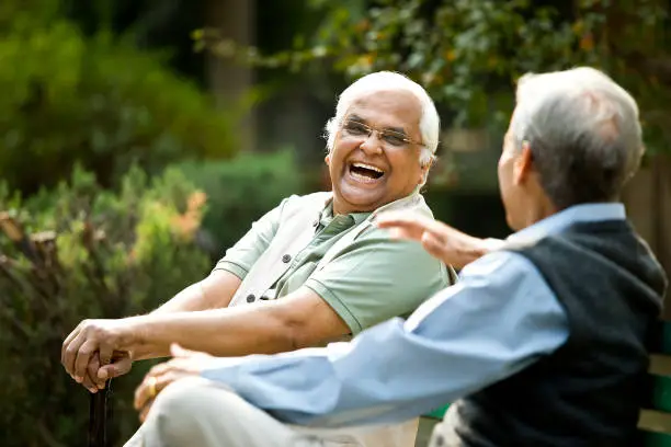 Photo of Two senior men discussing on park bench