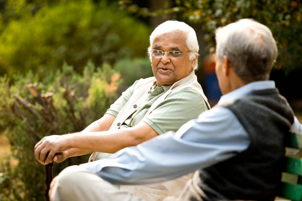 istock Two senior men discussing on park bench 1289142915
