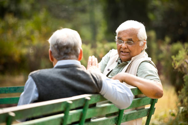 istock Two senior men discussing on park bench 1289142983