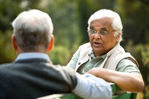 istock Two senior men discussing on park bench 1289143018