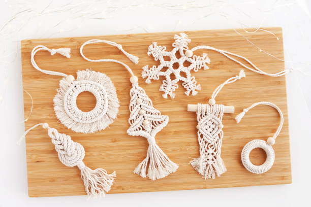 christmas macrame decor. christmas tree, ring, snowflake in the style of macramé. natural materials - cotton thread, wood beads. eco decorations, ornaments, hand made decor. winter  holidays - christmas tree bead humor imagens e fotografias de stock