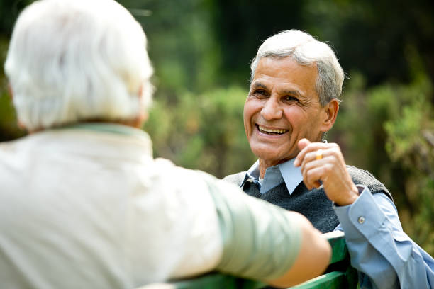 istock Two senior men discussing on park bench 1289143057