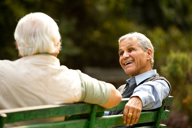 istock Two senior men discussing on park bench 1289143725