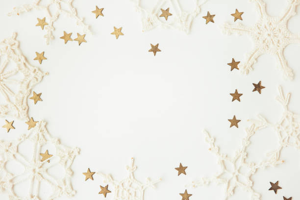 istock White snowflakes and gold stars on the white background, copy space for text 1289143953