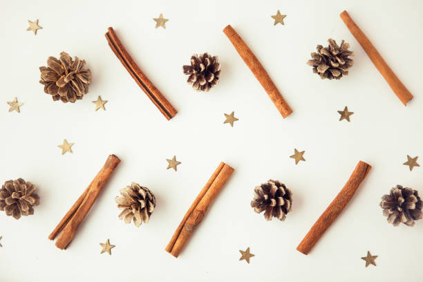istock Pine corns, gold stars and cinnamon sticks on the white background 1289143956