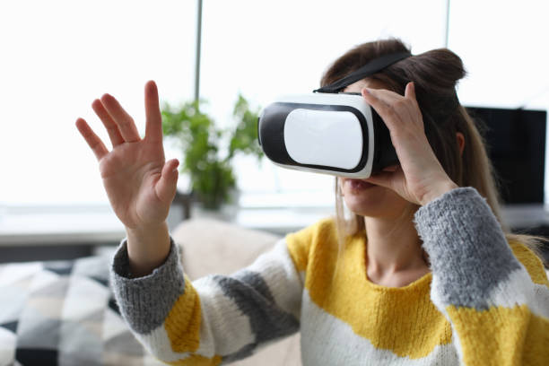 istock Woman in electronic professional virtual reality glasses watch simulator video. 1289144720
