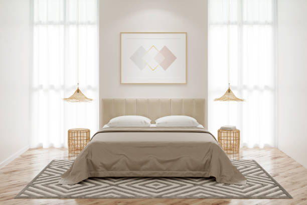 istock Interior of a bedroom with a horizontal poster on the wall between two windows, a bed with wicker chandeliers over bamboo bedside tables, and a beige carpet on the parquet floor. Front view. 1289144776