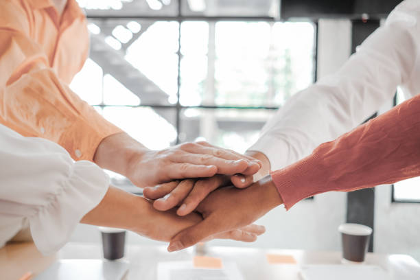 istock Businesspeople teamwork group putting their hands together agreement plan in meeting room, investment concept, success concept