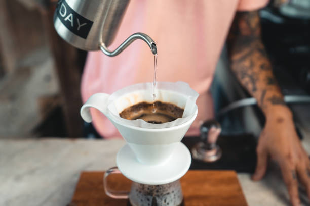 istock Drip coffee, barista pouring water on coffee ground with filter,brewing coffee 1289146264