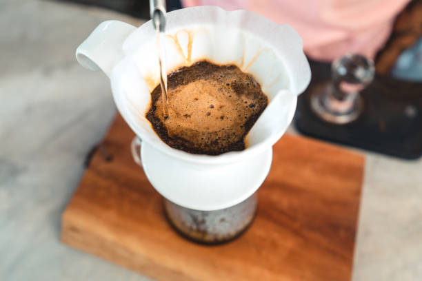 istock Drip coffee, barista pouring water on coffee ground with filter,brewing coffee 1289146915