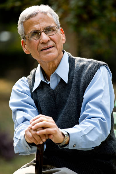 istock Senior man with walking cane at park 1289147099